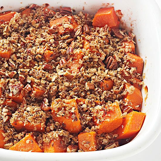 a casserole dish filled with sweet potatoes and pecans