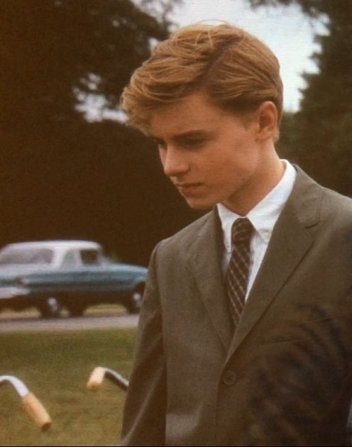 a young man wearing a suit and tie