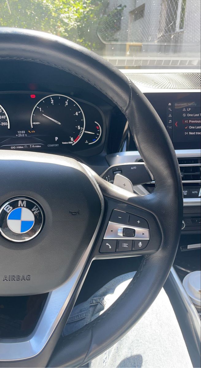 the steering wheel and dashboard of a bmw car