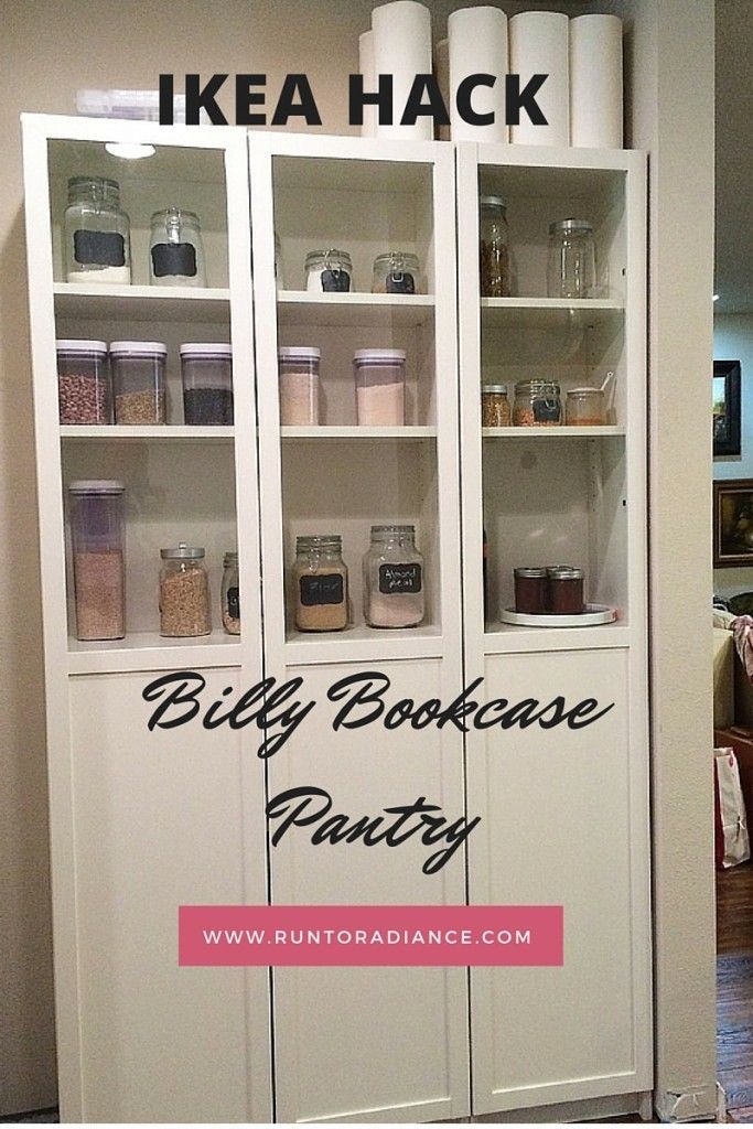 a white bookcase filled with lots of books and jars next to a kitchen counter