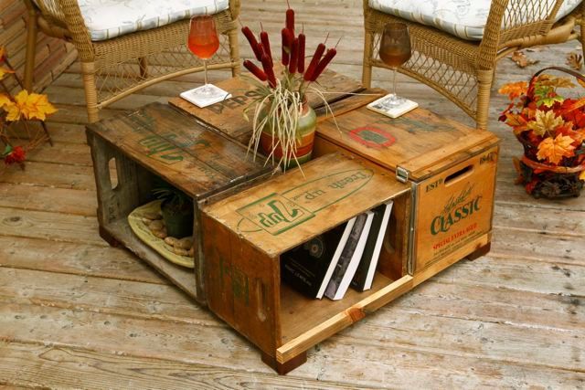 an old crate is used as a coffee table and end table for the outdoor seating area