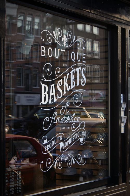 an image of a store window with the words boutique baskets written in white on it