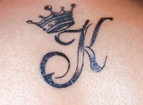 a tattoo with the letter k and a crown on it