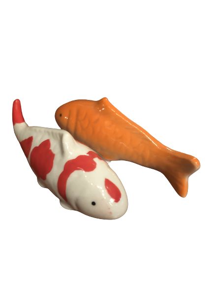 two ceramic fish on white background one is orange and the other is red