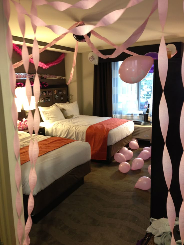 an instagramted photo of a hotel room with pink streamers hanging from the ceiling