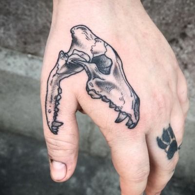 a person's hand with a tattoo on it