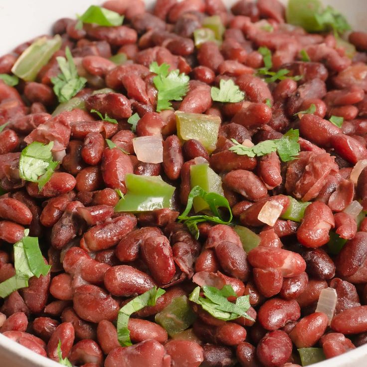 a white bowl filled with red beans and cilantro