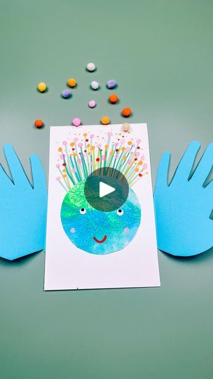 two hands holding up a card with an image of a plant on it and colorful sprinkles