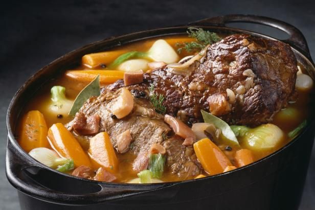 a pot filled with meat and vegetables on top of a table