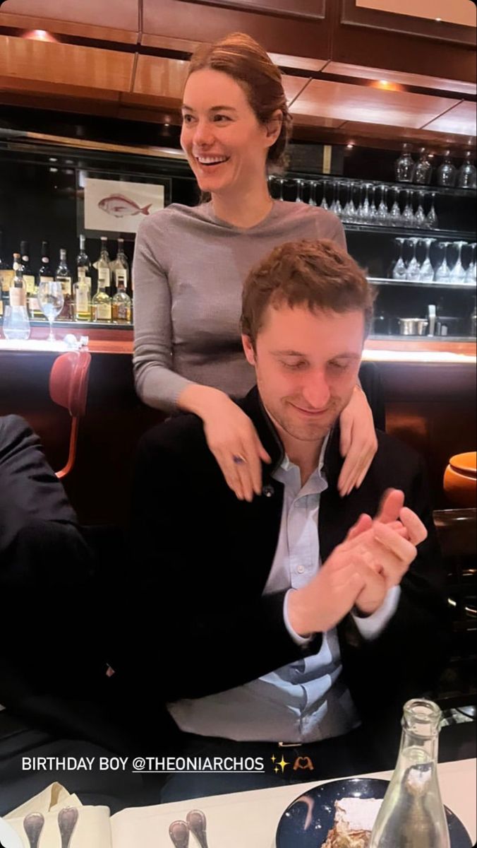 a man sitting next to a woman at a table