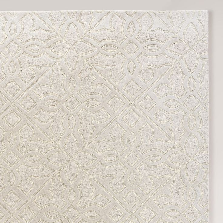 a white rug with an intricate design on it