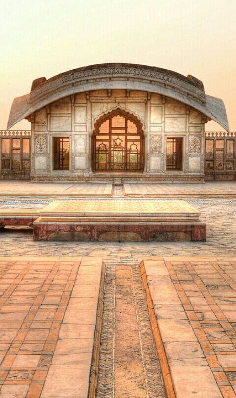 an old building with two benches in front of it