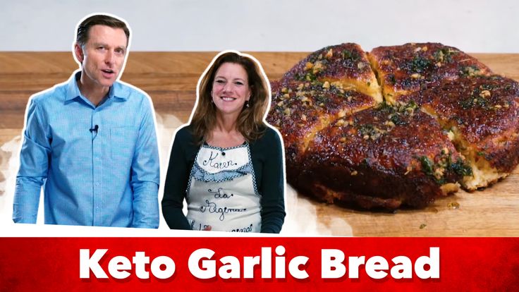 a man and woman standing next to a keto garlic bread