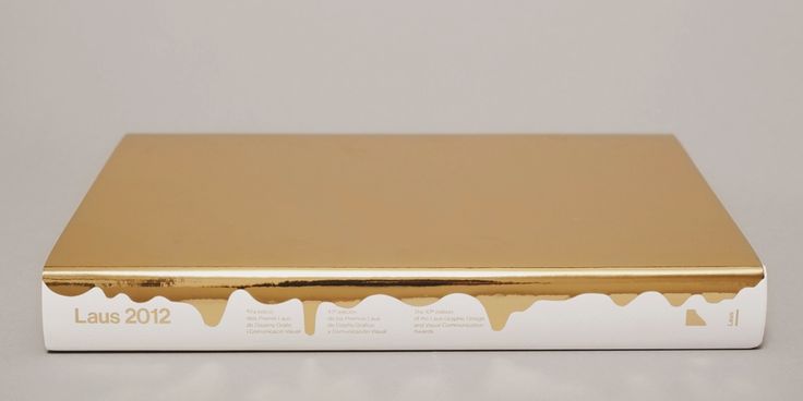 a gold colored box with white writing on the front and bottom, sitting against a gray background