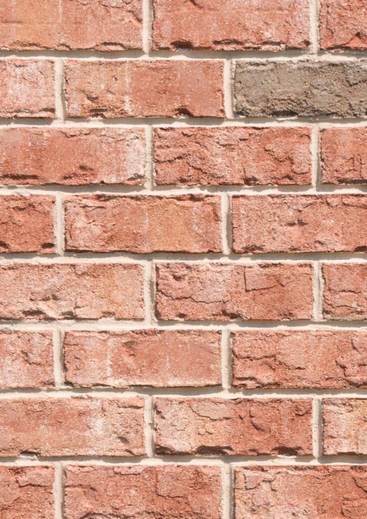 a red brick wall that is very close up