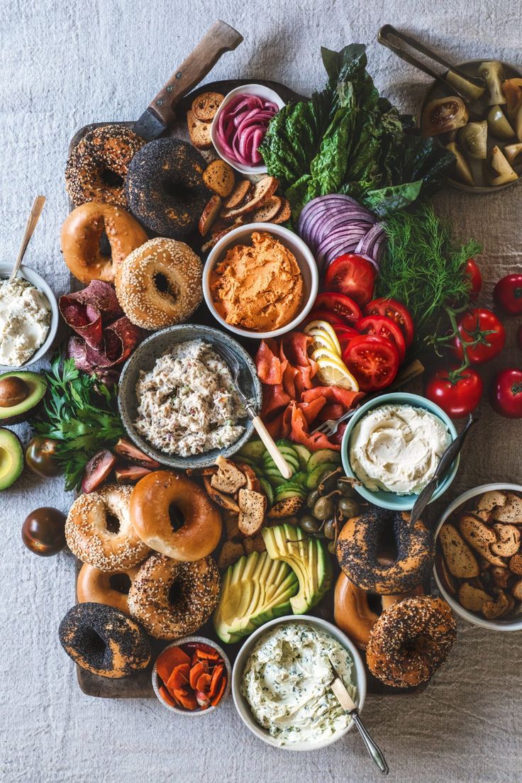 a table topped with lots of different types of food and dipping sauces on top of each other