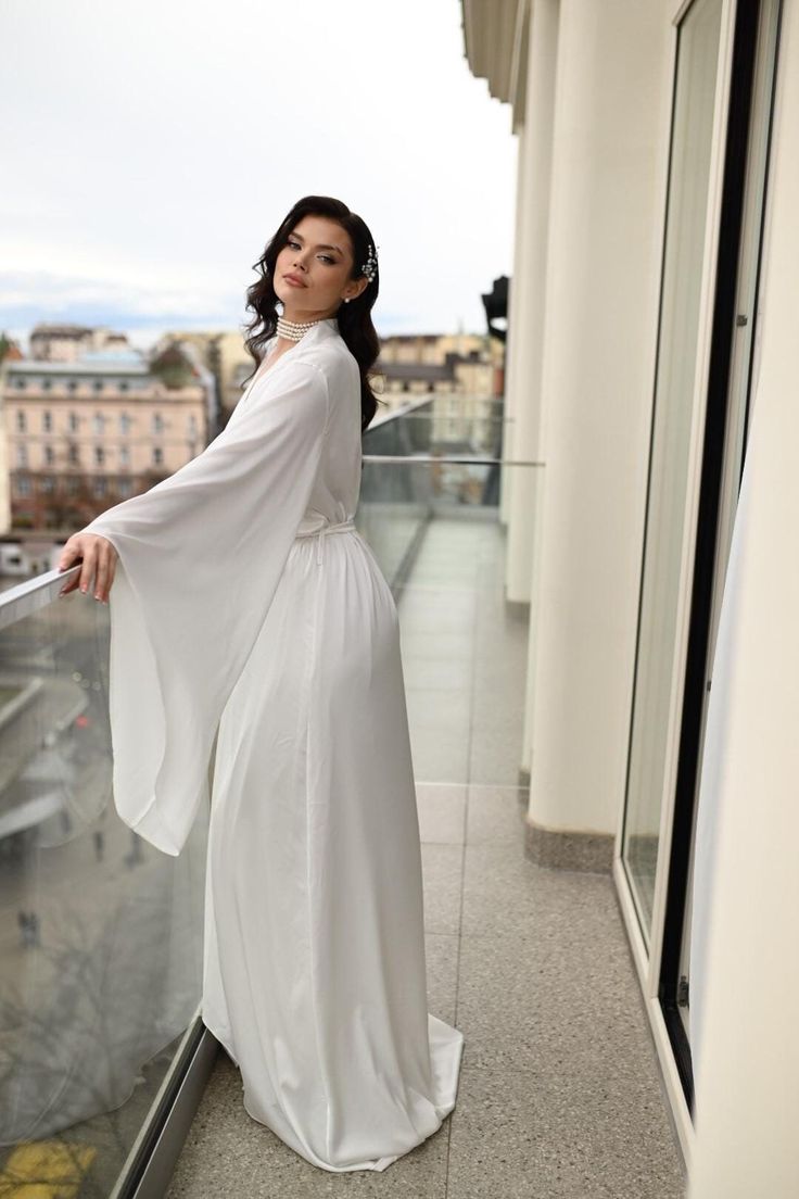 Make your wedding day morning even more special with our silk wedding robe with wide sleeves and train. This luxurious bridal robe is handmade from the highest quality silk, ensuring you feel as beautiful as you look. The wide sleeves add a touch of sophistication, giving you a graceful silhouette as you prepare for your big day. The soft, smooth silk fabric drapes effortlessly, providing an unmatched blend of comfort and elegance. * Front length 145 cm / 57 in * Train length 190 cm / 75 in * Ha Wedding Day Morning, Robe Bridesmaids, Long Bridal Robe, Silk Bridal Robe, Robe Wedding, Bridal Robe, Wedding Robe, Bride Getting Ready, Etsy Bridesmaid Gifts