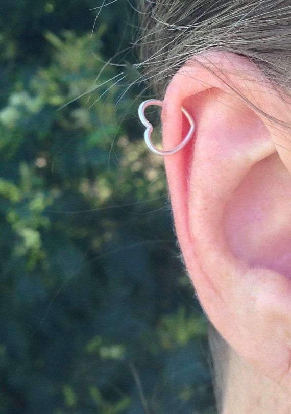 a close up of a person wearing a pair of ear piercings