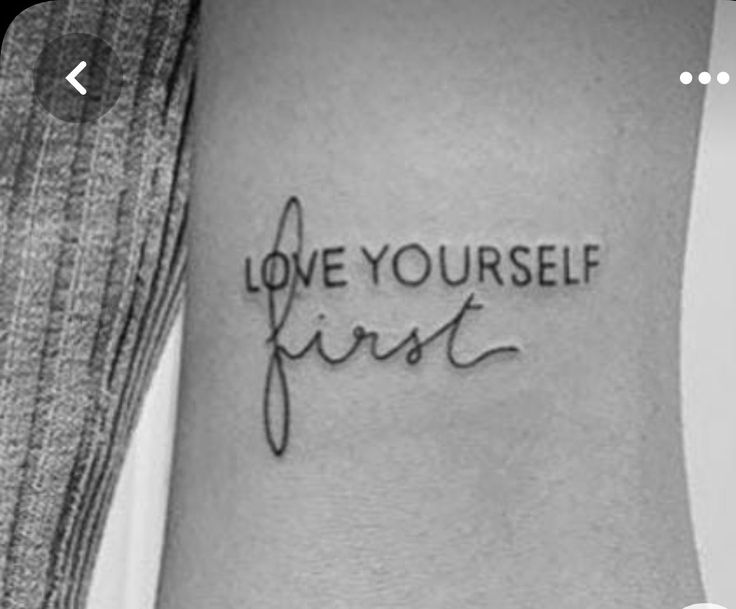 a tattoo with the words love yourself first on it