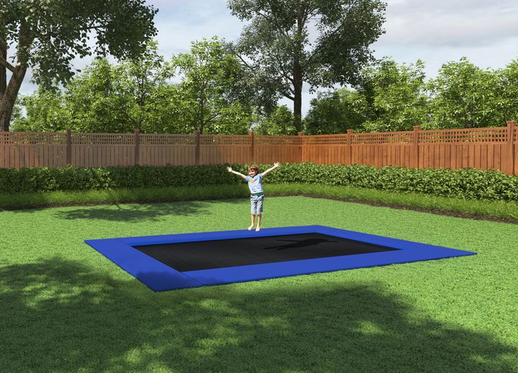 a person standing on top of a blue trampoline