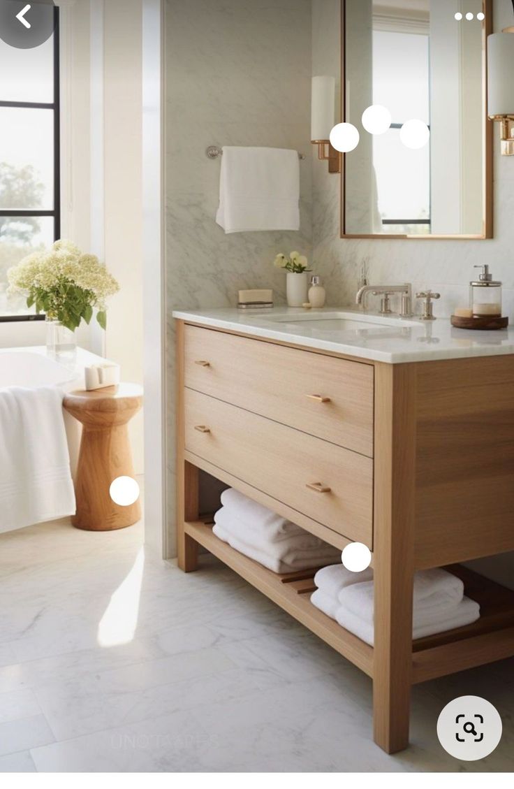 a bathroom with a sink, mirror and bathtub in it's center area