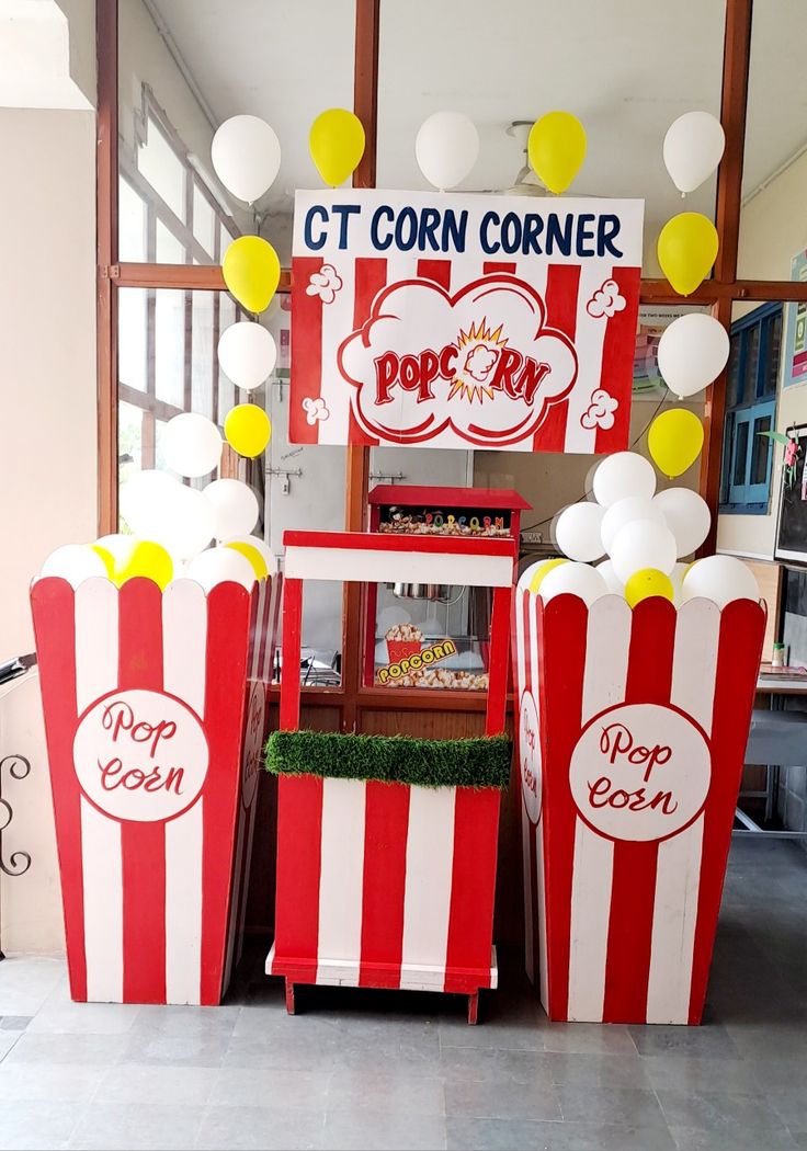 some popcorn boxes are set up with balloons