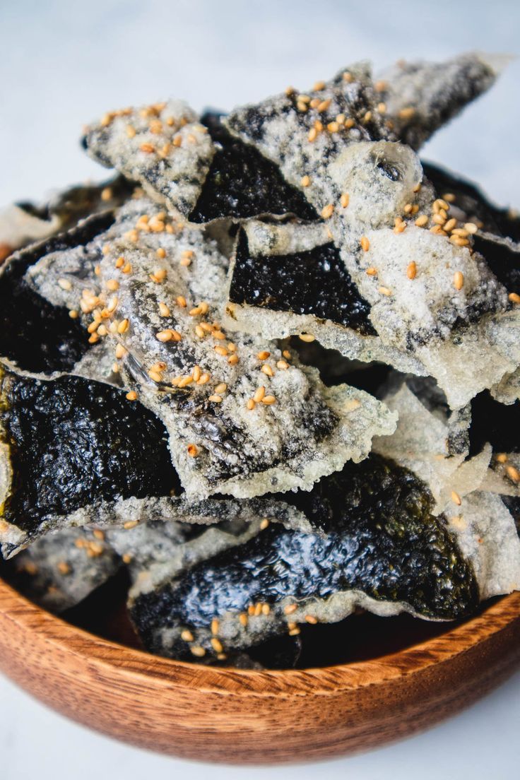 a wooden bowl filled with black and white food