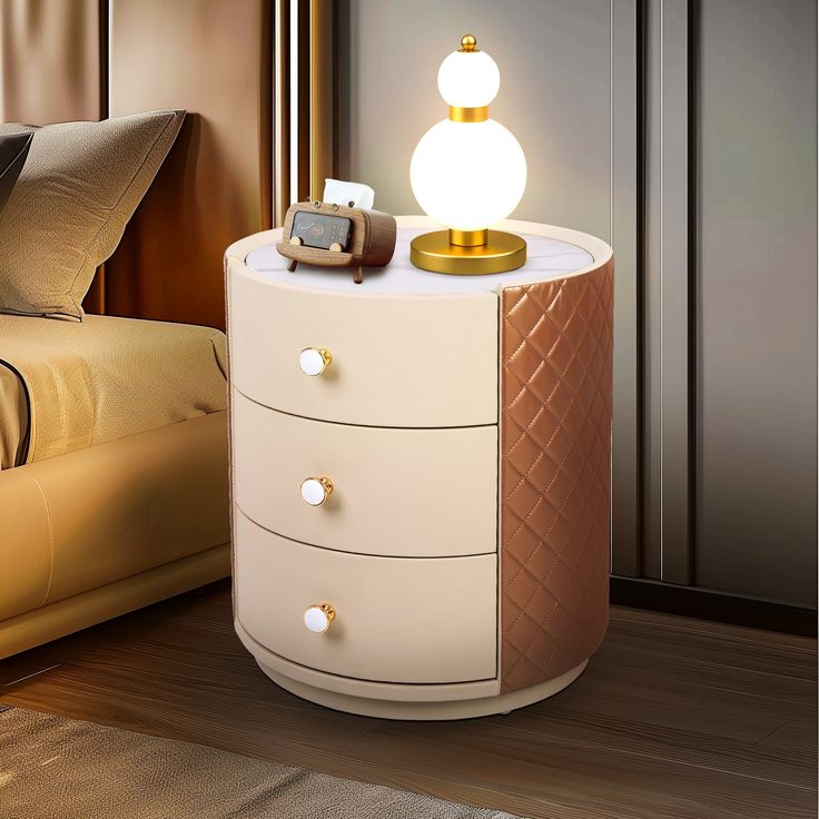 a night stand with two drawers and a phone on it, next to a bed