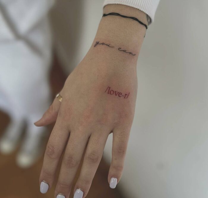 a woman's hand with a tattoo saying i love it