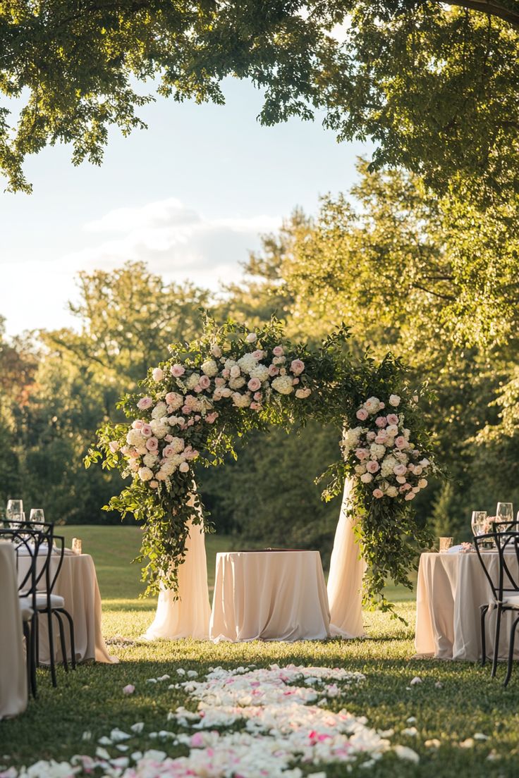 an outdoor ceremony setup with flowers and greenery