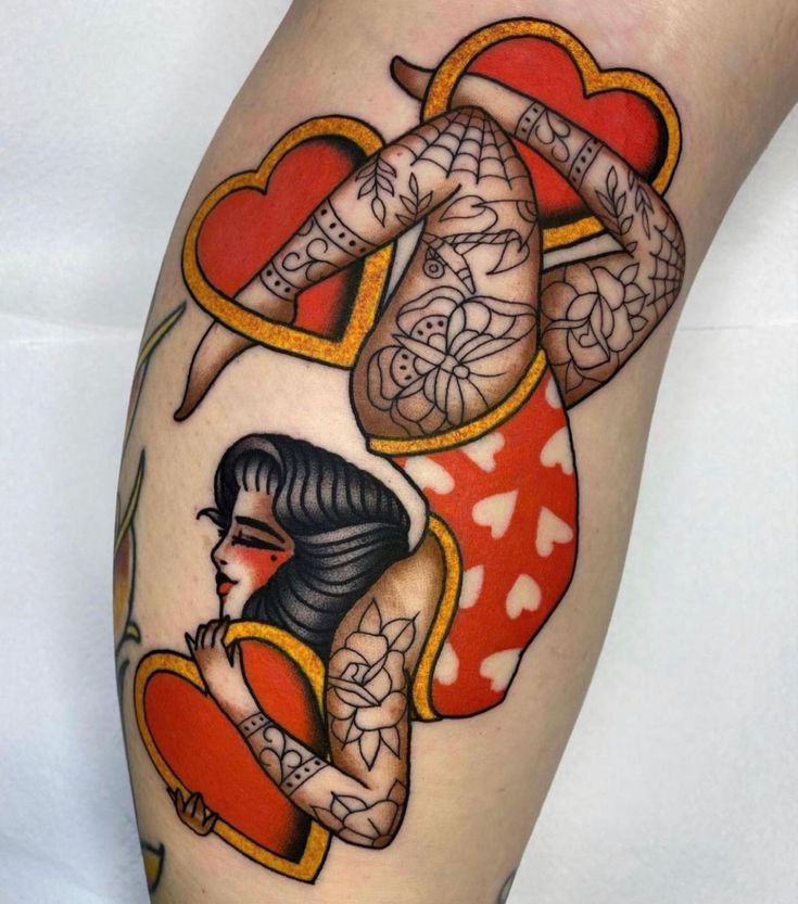 a woman's leg with tattoos on it and hearts in the shape of heart