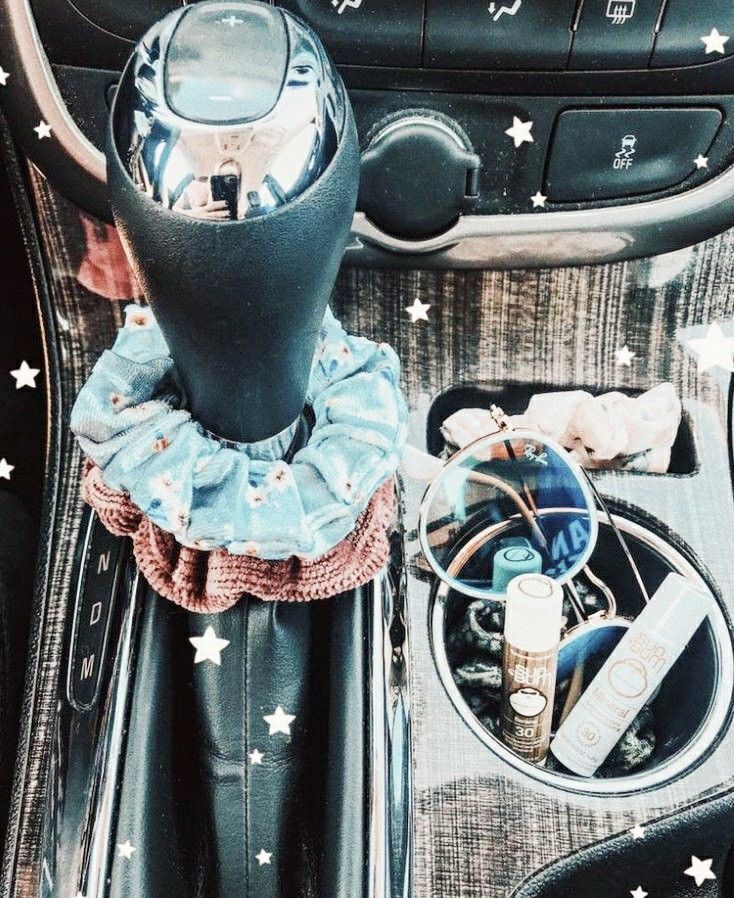 the interior of a car with various items in it, including an air vent and steering wheel