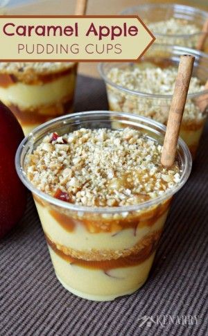 caramel apple pudding cups with apples and cinnamon sticks in the background on a table