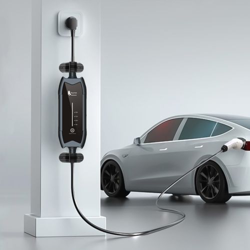 an electric car plugged in to a charger and charging it on the wall