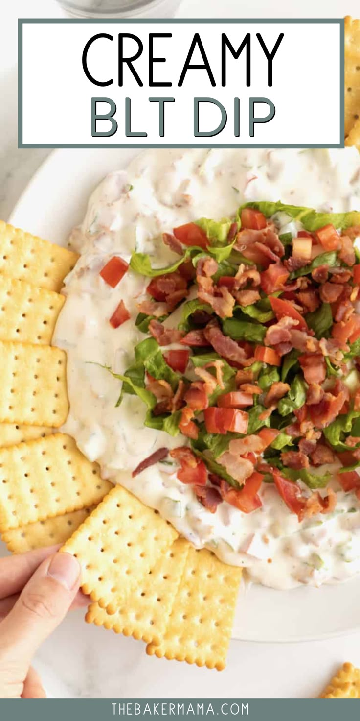 a white plate topped with crackers, bacon and lettuce next to a bowl of dip