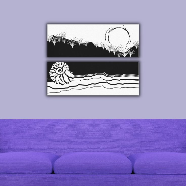 a purple couch sitting in front of a painting on the wall