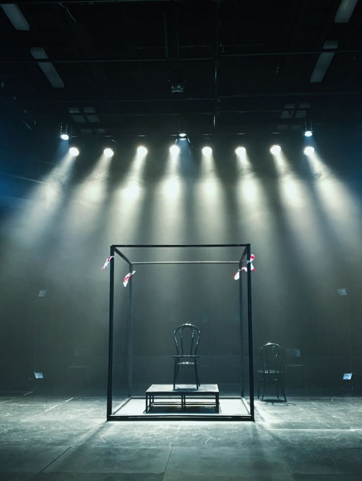 an empty stage with chairs and lights