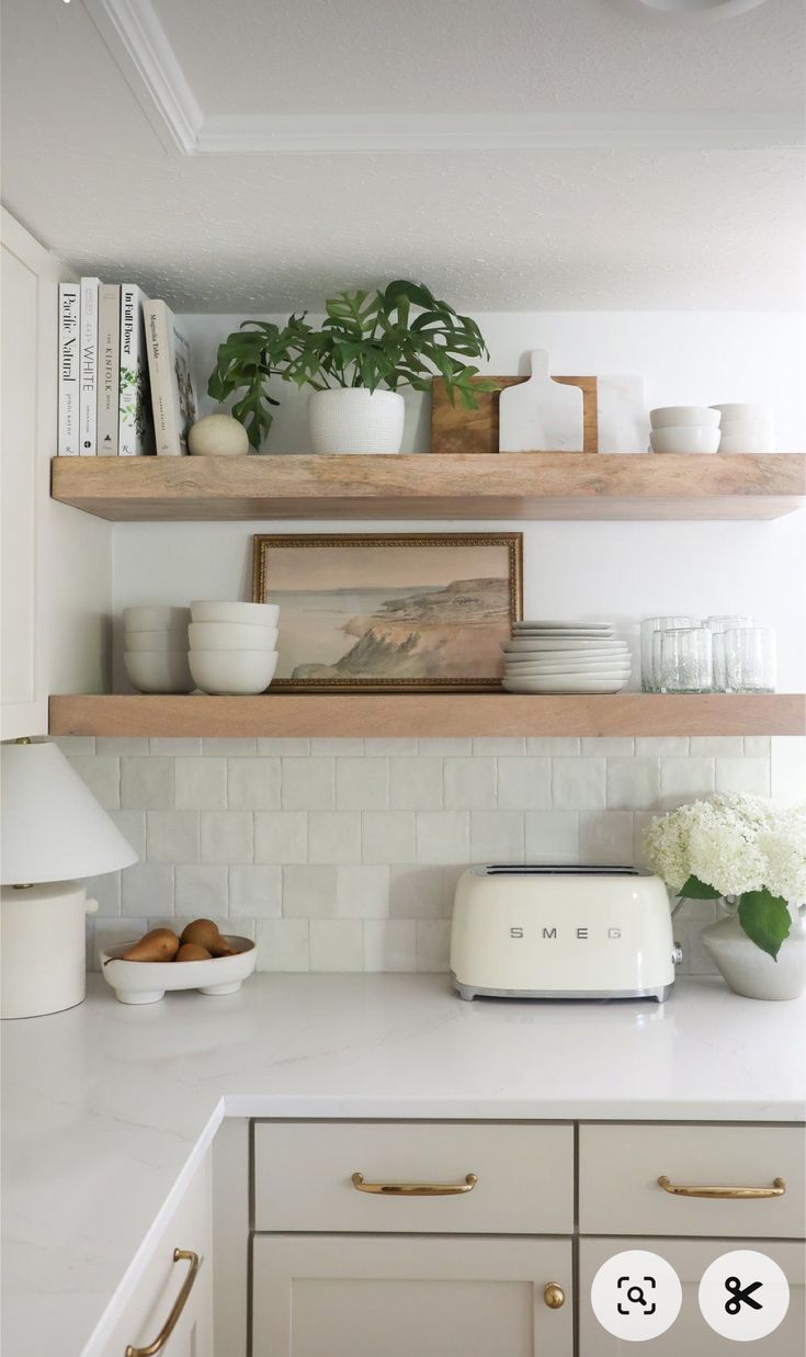 a kitchen with open shelves and white counter tops