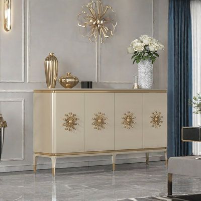 a white and gold sideboard in a living room