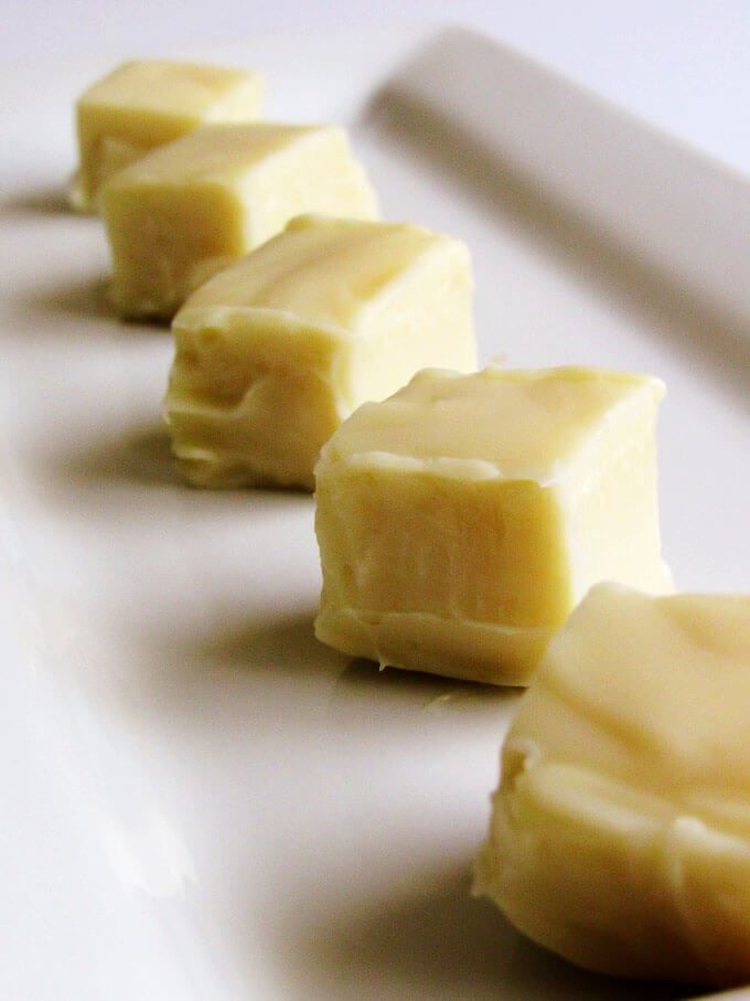 four pieces of butter sitting on top of a white plate