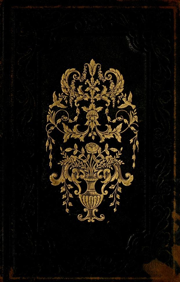 an ornate book with gold foil on black paper and golden trimmings, in the middle