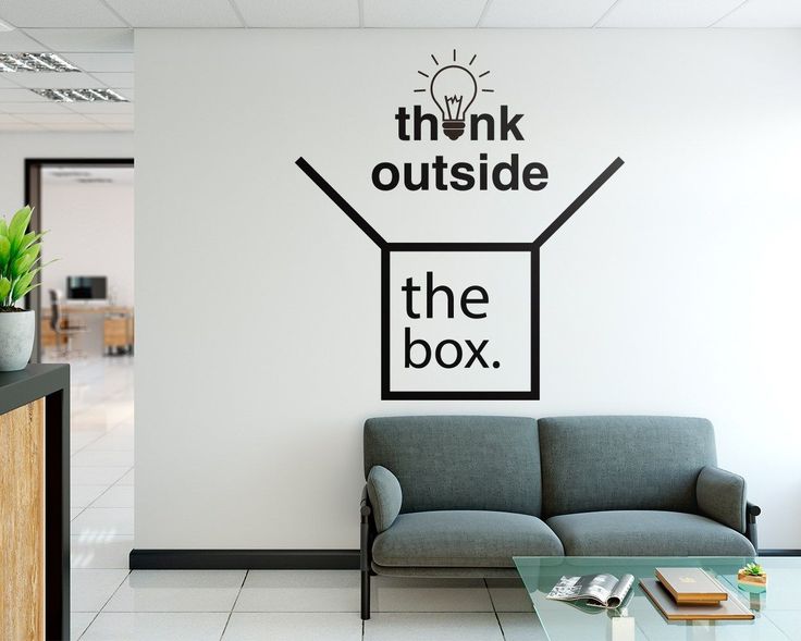 the think outside the box wall decal is shown in an office setting with a couch and coffee table