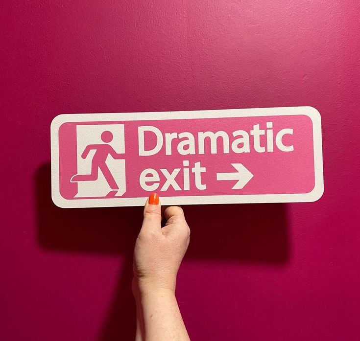 a hand is pointing to a pink sign with the words dramatic exit and an arrow