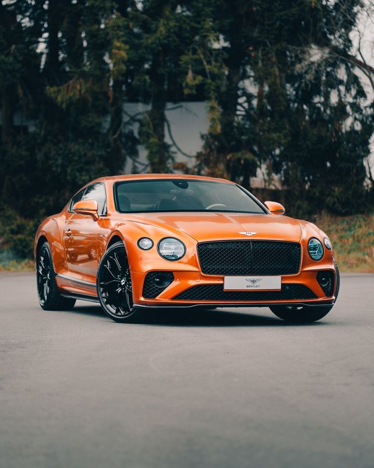 an orange sports car parked on the street