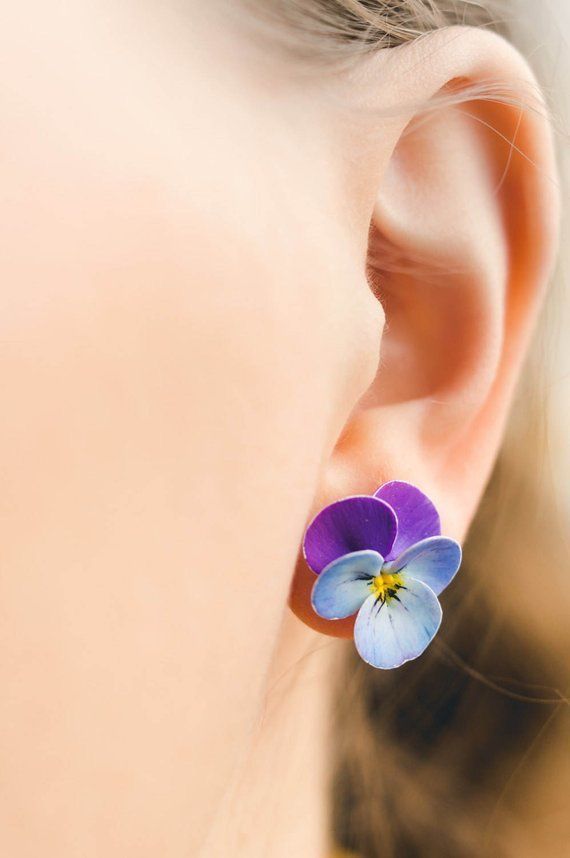 a close up of a person's ear with a flower in the middle of it