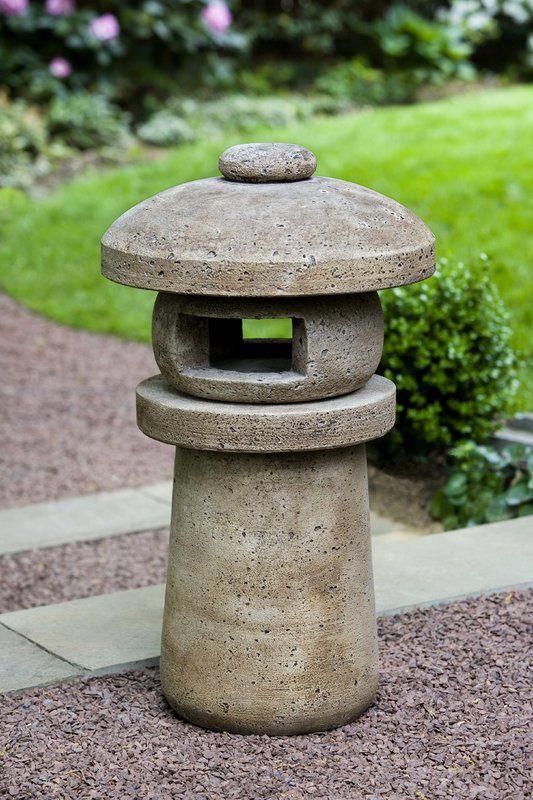 a stone lantern sitting on top of a sidewalk