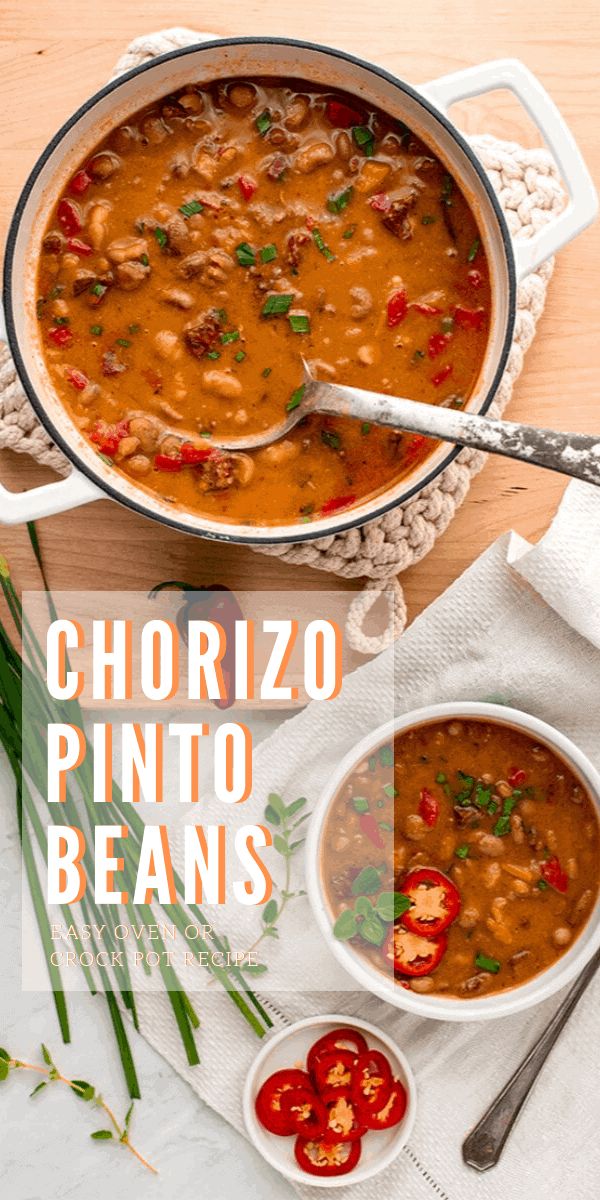 two bowls of chorizzo pinto bean soup on a table with tomatoes and herbs