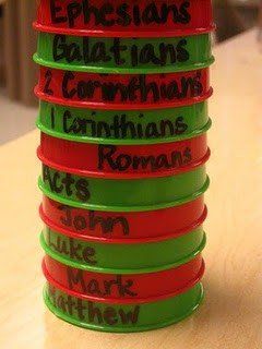 a stack of red and green plastic cups with words written on them sitting on a table