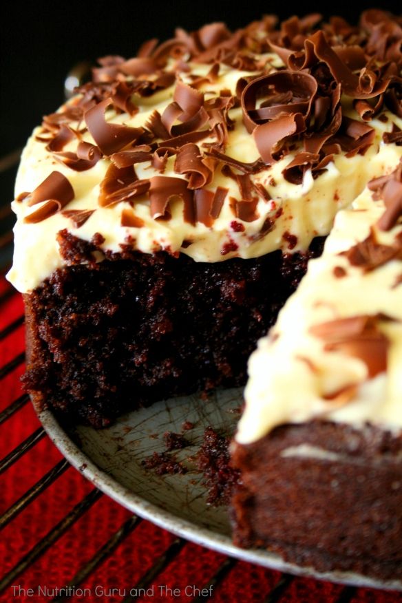 a chocolate cake with white frosting and chocolate sprinkles