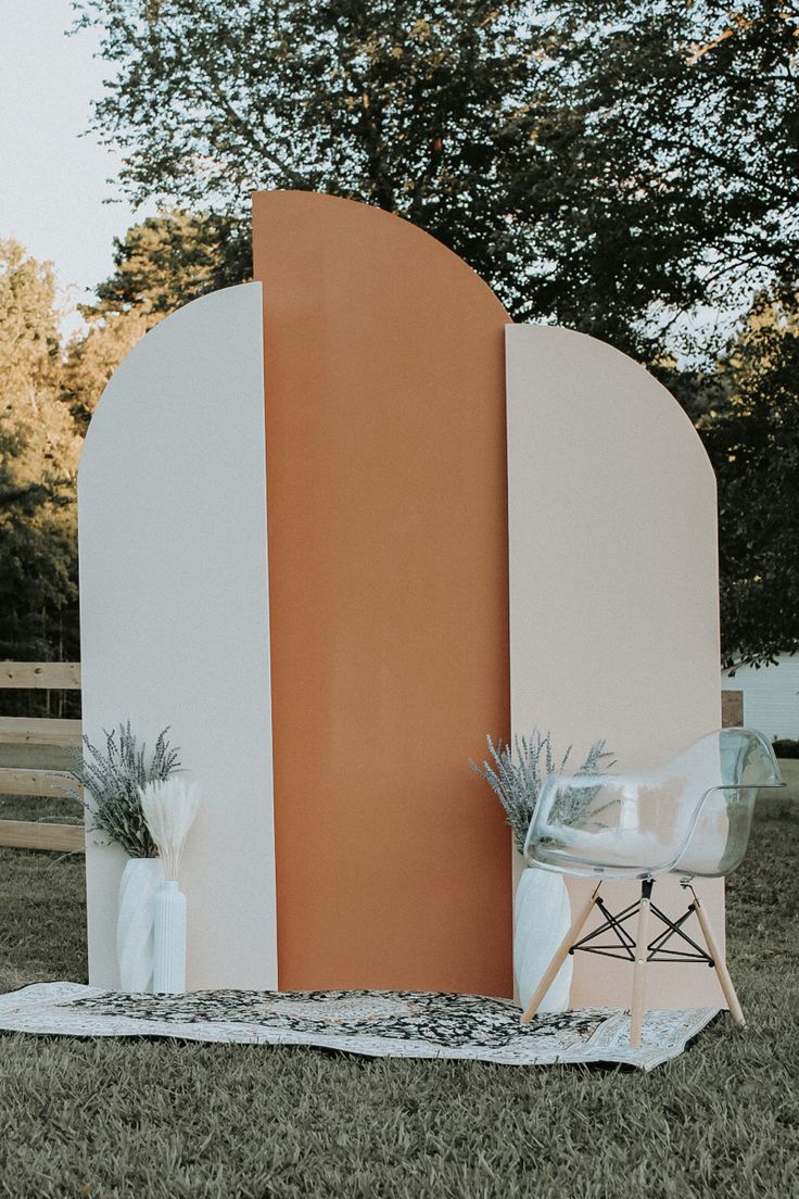 an orange and white booth sitting in the grass